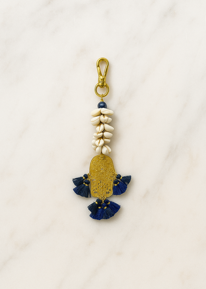 Decorative keychain with blue and gold elements on a white background