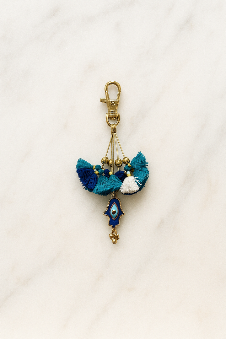 Decorative keychain with tassels and evil eye charm on a white background
