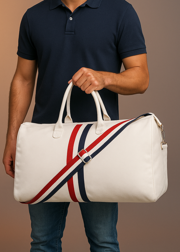 Man holding a white duffel bag with red and blue stripes against a brown background