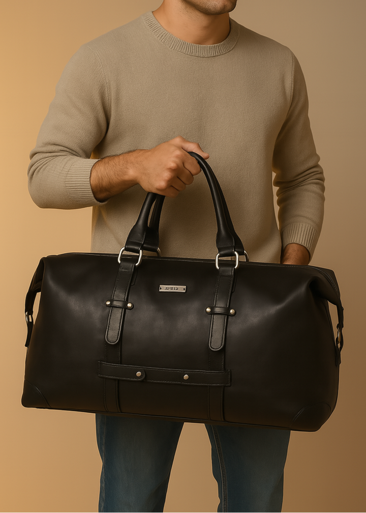 Man holding a black leather duffel bag against a beige background